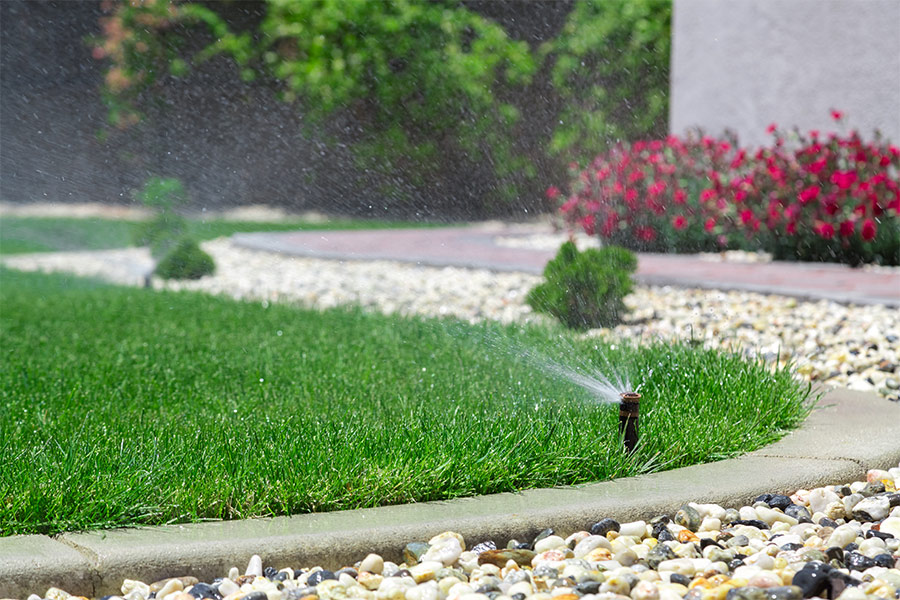 lawn-irrigation-in-process-with-sprinkler-system-installed-at-residential-property-cottonwood-ca